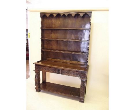 A Victorian oak dresser with four tier back over elaborately carved base, the frieze with boar and stag hunting scenes all ra