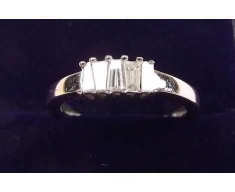 An 18k white gold ring set five tapered baguette cut diamonds - size L