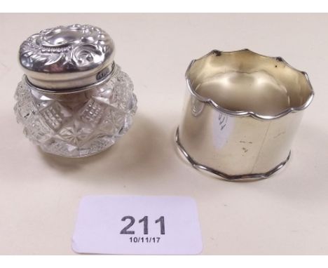 A cut glass and silver topped dressing table pot and a silver napkin ring