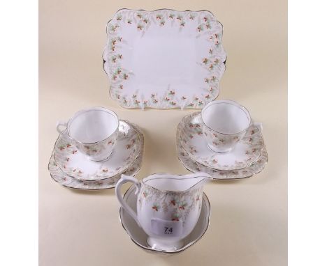 A Royal Albert tea service comprising: milk, sugar, cake plate, six cups and saucers and six plates