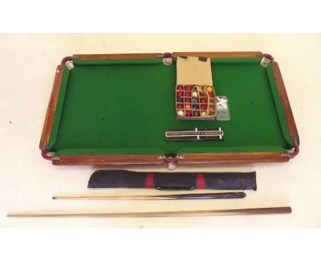 A Rileys quarter size slate bed snooker table with cues, balls and scoreboard