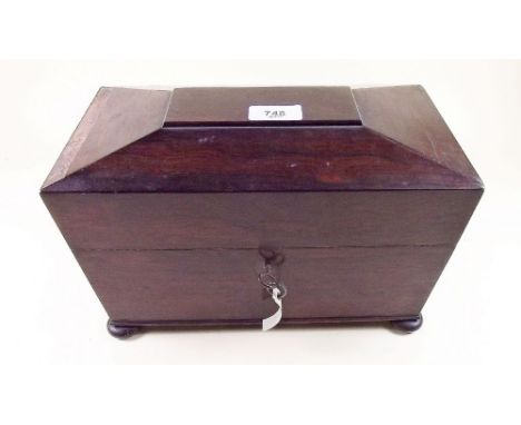 A Regency rosewood sarcophagus form tea caddy with ring handles and bun feet