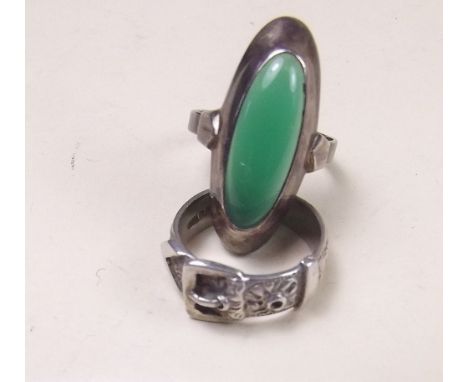 A silver buckle ring and a silver ring set green stone