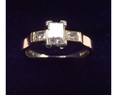 An 18 carat gold ring set cushion cut diamond on baguette cut shoulders - size K