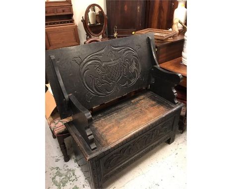 A Monks bench with carved Coat of Arms