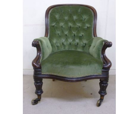 A William IV mahogany showwood framed spoonback grandfather chair, the enclosed level arms on scroll carved supports, part bu