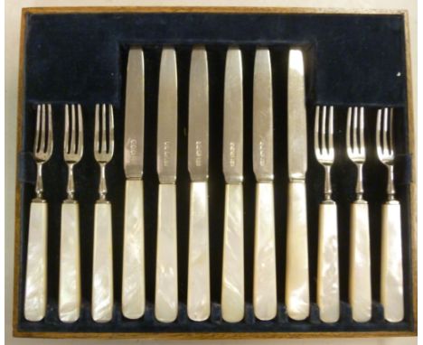 A set of six silver dessert knives and forks, on chamfered mother-of-pearl handles  Mappin & Webb  Sheffield 1922 in a fitted