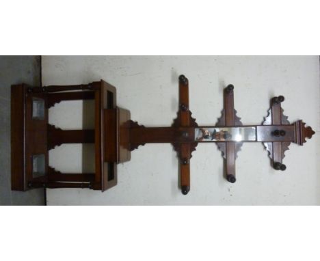 A late Victorian mahogany hallstand, the three tiered superstructure incorporating a central slip mirror and an arrangement o
