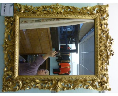 A mid 19thC mirror, set in an ornately scrolled gilt gesso frame  35'' x 26''