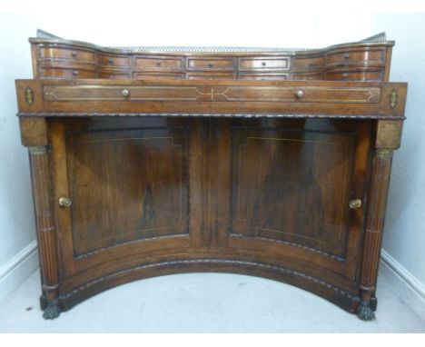 A Regency lady's lacquered brass inlaid, bead and reel carved rosewood writing desk, having straight sides and a twin panelle