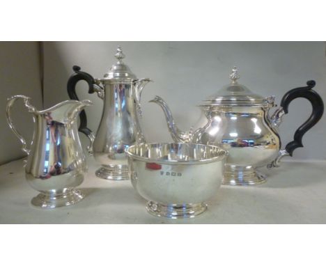 A Georgian style four piece silver tea set  comprising a teapot of bulbous form, having an S-shaped, foliate cast spout, a ca