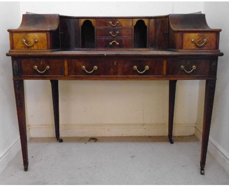 An Edwardian mahogany Carlton House desk, having a lacquered brass galleried superstructure, over an arrangement of short dra