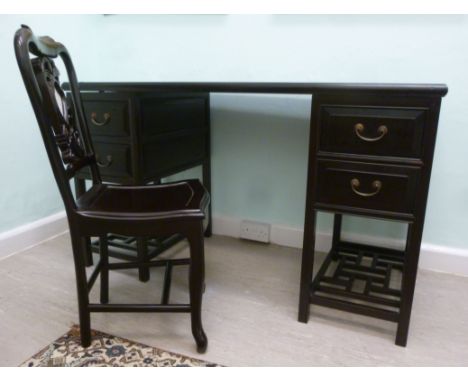 A 20thC Chinese black lacquered elm kneehole desk, the top having mitred corners and fielded panelled sides, over twin pedest