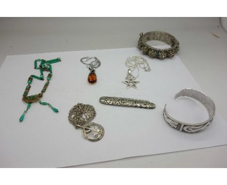 Three silver pendants with chains, an Art Deco necklet and two bangles