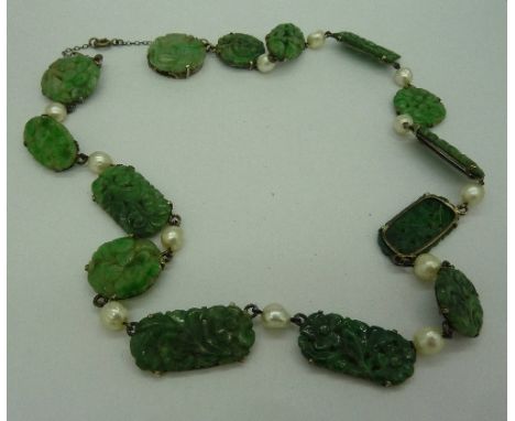 An early 20th Century Art Deco carved jade and pearl necklet, two pieces of jade a/f