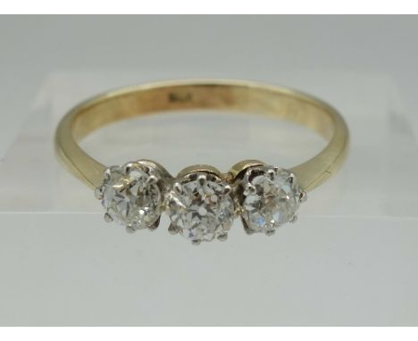 A c.1920's 18ct gold, old mine cut diamond trilogy ring, approximately 1 carat diamond weight, weight 2.6g, size R