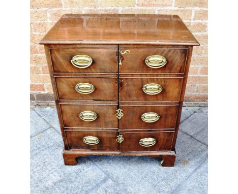 MAHOGANY FRAMED CHEST, of small proportion, with two doors to each side opening to reveal a fitted shelf, 75cm x 66cm x 45cm