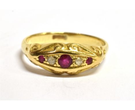 A C1900 RUBY AND DIAMOND SET BOAT HEAD RING  the central ruby approx. 3mm diameter, the shank stamped 18ct, size O ½, gross w