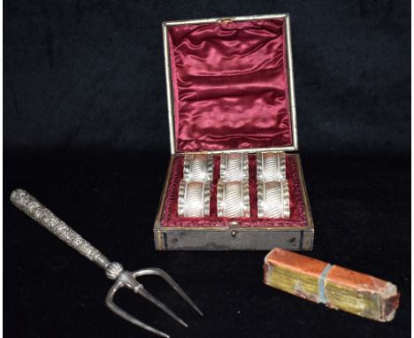 A SILVER HANDLED TOASTING FORK  Together with a set of six white metal napkin rings, unmarked, boxed; and a set of small bras