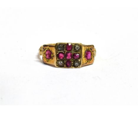 A LATE VICTORIAN RUBY AND DIAMOND 18CT GOLD RING The square head with a cross of diamonds between and ruby set shoulders, siz