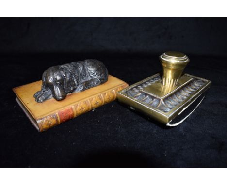 A VICTORIAN BRASS MOUNTED DESK BLOTTER  17cm wide, and a composition paperweight in the form of a dog sleeping on a book Cond
