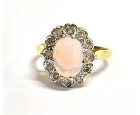 AN OPAL AND DIAMOND CLUSTER 18CT GOLD RING  the oval cluster comprising a centre cabochon cut opal, 9 x 7mm with a surround o