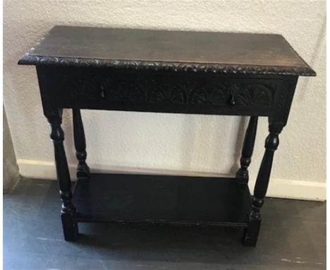 A CARVED OAK SIDE TABLE, with single frieze drawer above a stretcher shelf, 77cm x 84cm x 48cm