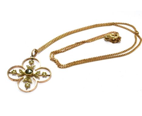AN EDWARDIAN 9CT GOLD PERIDOT AND SEED PEARL PENDANT  On a later 9ct gold chain, the four leaf clover shaped openwork pendant