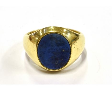 A GENT'S HALLMARKED 18CT GOLD LAPIS LAZULI SET SIGNET RING  The oval tablet of Lapis Lazuli 15mm long, size R, gross weight a