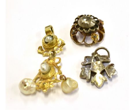 THREE 18TH/19TH CENTURY PENDANTS Comprising a baroque pearl set yellow metal drop pendant 35 mm long and two small rose cut d