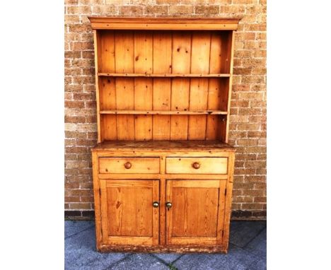 VICTORIAN PINE DRESSER, the upper section having a panelled with a cornice above a two shelf plate rack the base with two dra