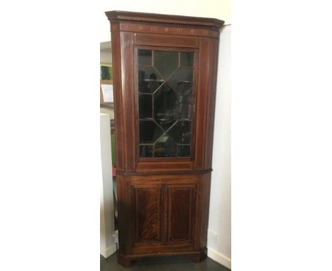 AN EDWARDIAN CORNER CABINET, the upper section having a cornice and glazed door, above two doors with a fitted shelf, 213cm x