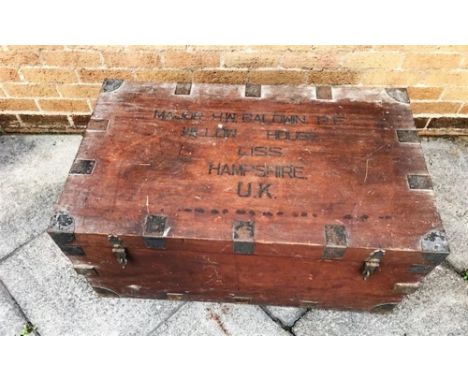 TEAK AND METAL BOUND CAMPHORWOOD TRUNK, raised on casters, 64cm x 120cm x 61cm