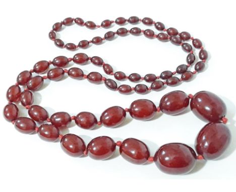 A single strand of cherry amber bakelite beads, the beads ranging from 9mm - 30mm, total length 100cm, gross weight 95g. Cond
