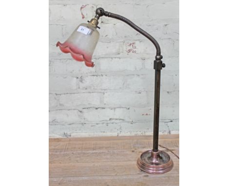 An early 20th century industrial style angle-poise adjustable lamp with copper base and etched cranberry glass shade, height 