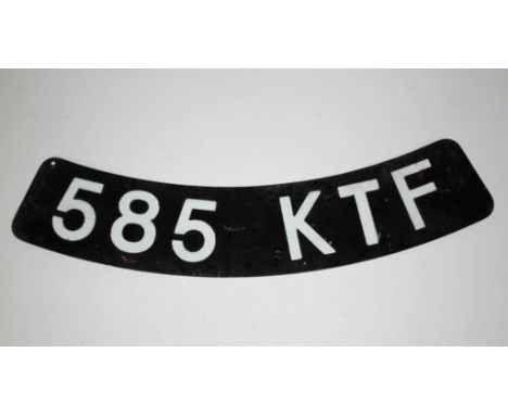 A vintage number plate '585 KTF' of curved form, length 33cm.  