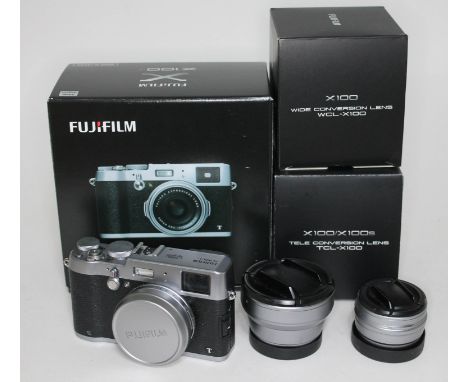 A Fujifilm X100T digital camera, with box, CD, manual, charger, strap, cables, battery and spare battery. Together with a Fuj