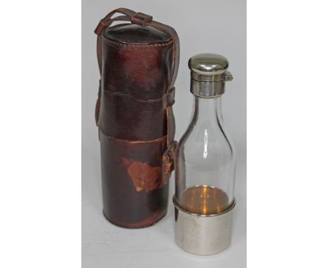 A silver plated and glass bottle with leather flask.  