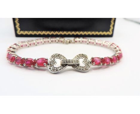 Vintage 15ct Ruby and Diamond Bracelet. A beautiful bracelet in sterling silver set with 25 x oval 6x4mm Rubies (15cts) with 