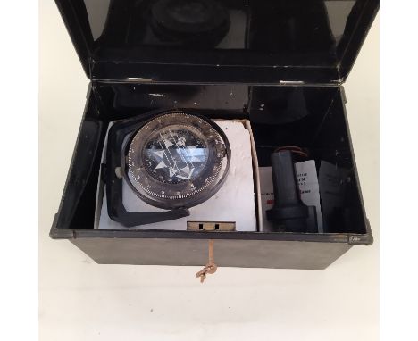 A tin box containing three boat compasses including a Heath-Marine 'Bosun' compass in original packing