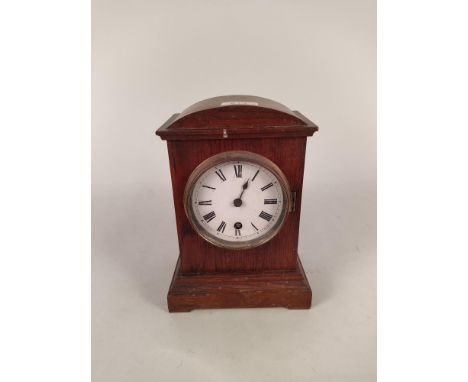 An Edwardian oak cased mantel clock