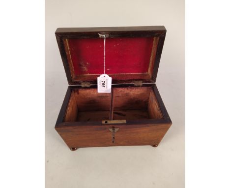 A Victorian rosewood veneered double section tea caddy with void interior and four bun feet, with key