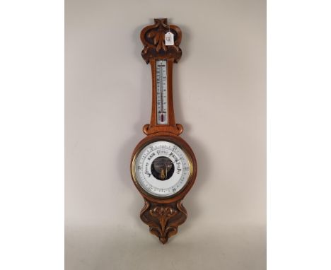 An oak banjo barometer with Art Nouveau influence, 33" long (crack to glass at top)