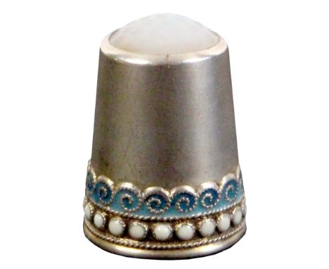 A Norwegian silver and enamel thimble by David Andersen, the beaded white dot enamel rim below a blue scroll enamel wave bord