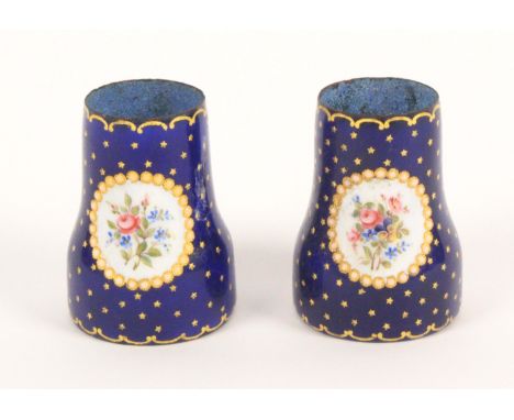 A pair of enamel decorated opera glass grips, 19th Century, French, each with two oval panels of flowers on a blue ground wit