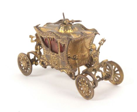 A gilt brass novelty tape measure in the form of the coronation coach, complete tape printed in ins. and cm., wound from the 