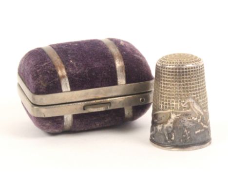 A 19th Century French 'fable' thimble, the fox and the crow, a little mis-shapen, in a metal and velvet trunk form case.Ê