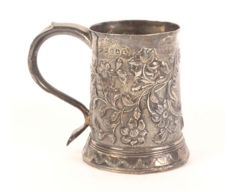 A Georgian silver mug, of tapering cylinder form with typical scroll handle, later engraved inscription and floral decoration