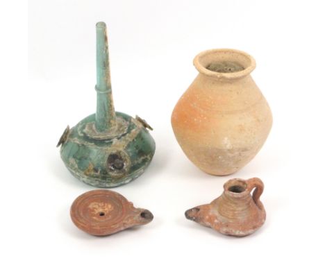 A collection of antiquities, comprising a Roman glass bottle with three applied flower motifs, 19cm, a red clay circular Roma