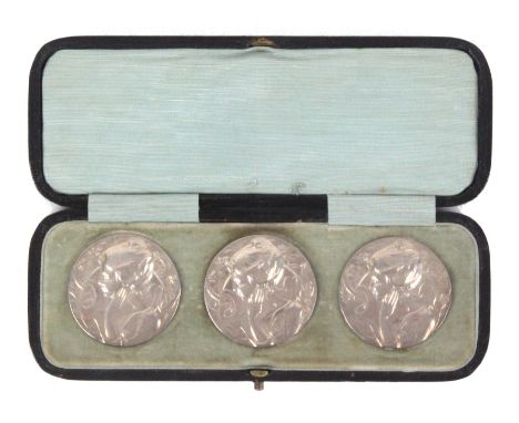 Buttons - a cased set of three large silver buttons each depicting a maiden's head amid foliage in the Art Nouveau style, Lon